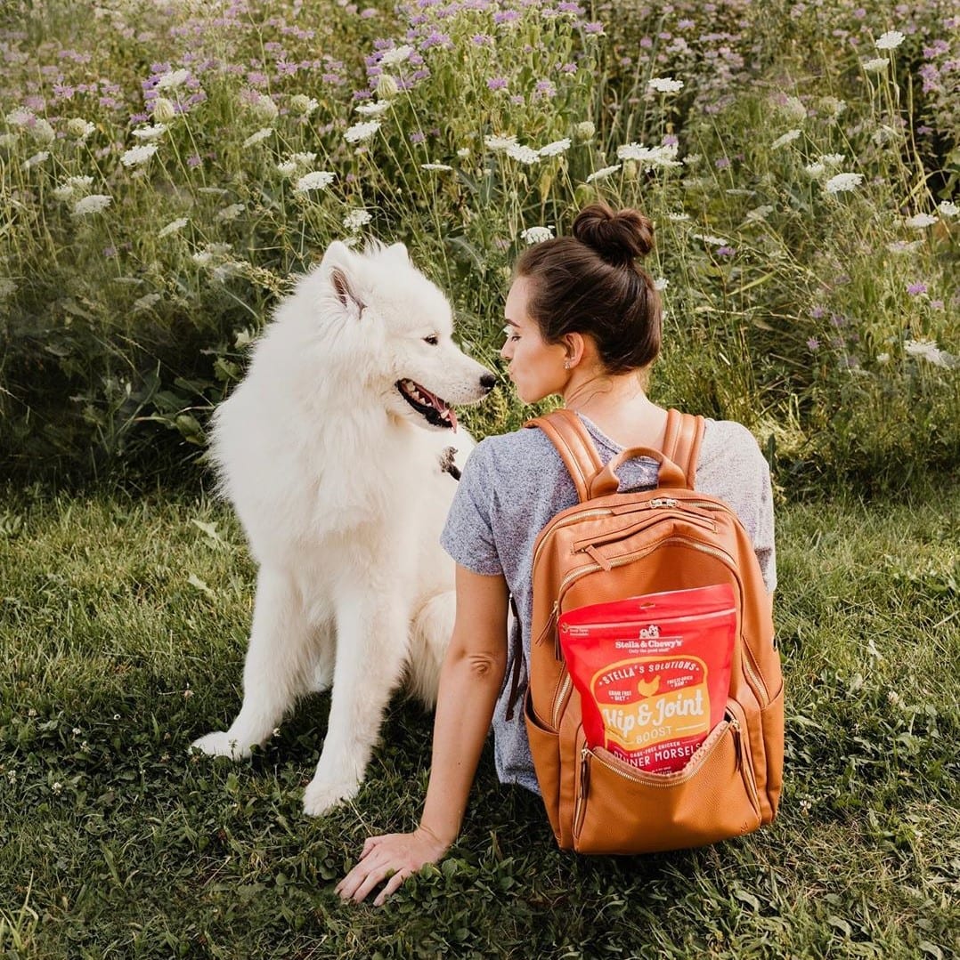 Dog and woman with bag of Stella’s Solutions Hip & Joint Support