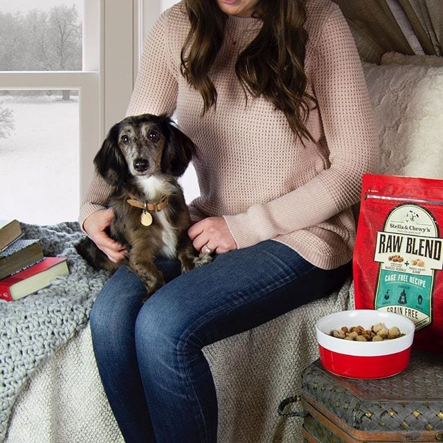 dog with bag of Cage Free Raw Blend Kibble